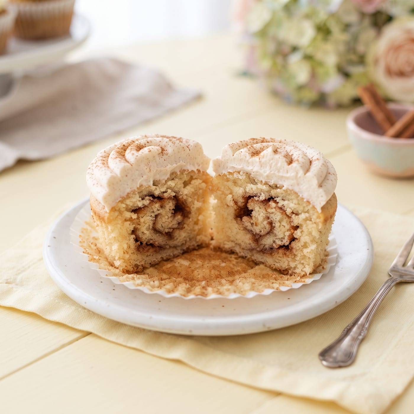 Cross section of a baked brown sugar cupcake showing the swirled cinnamon ribbon inside