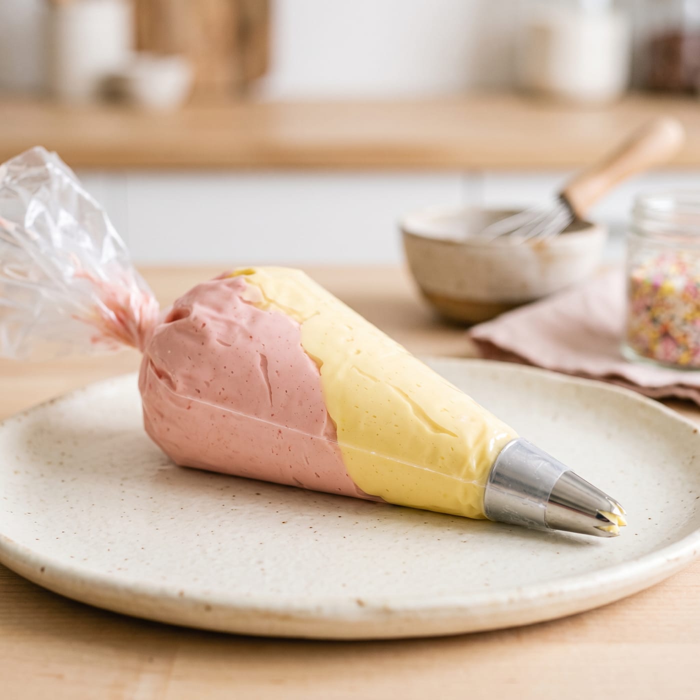 Piping bag loaded with two colors of frosting side by side before piping