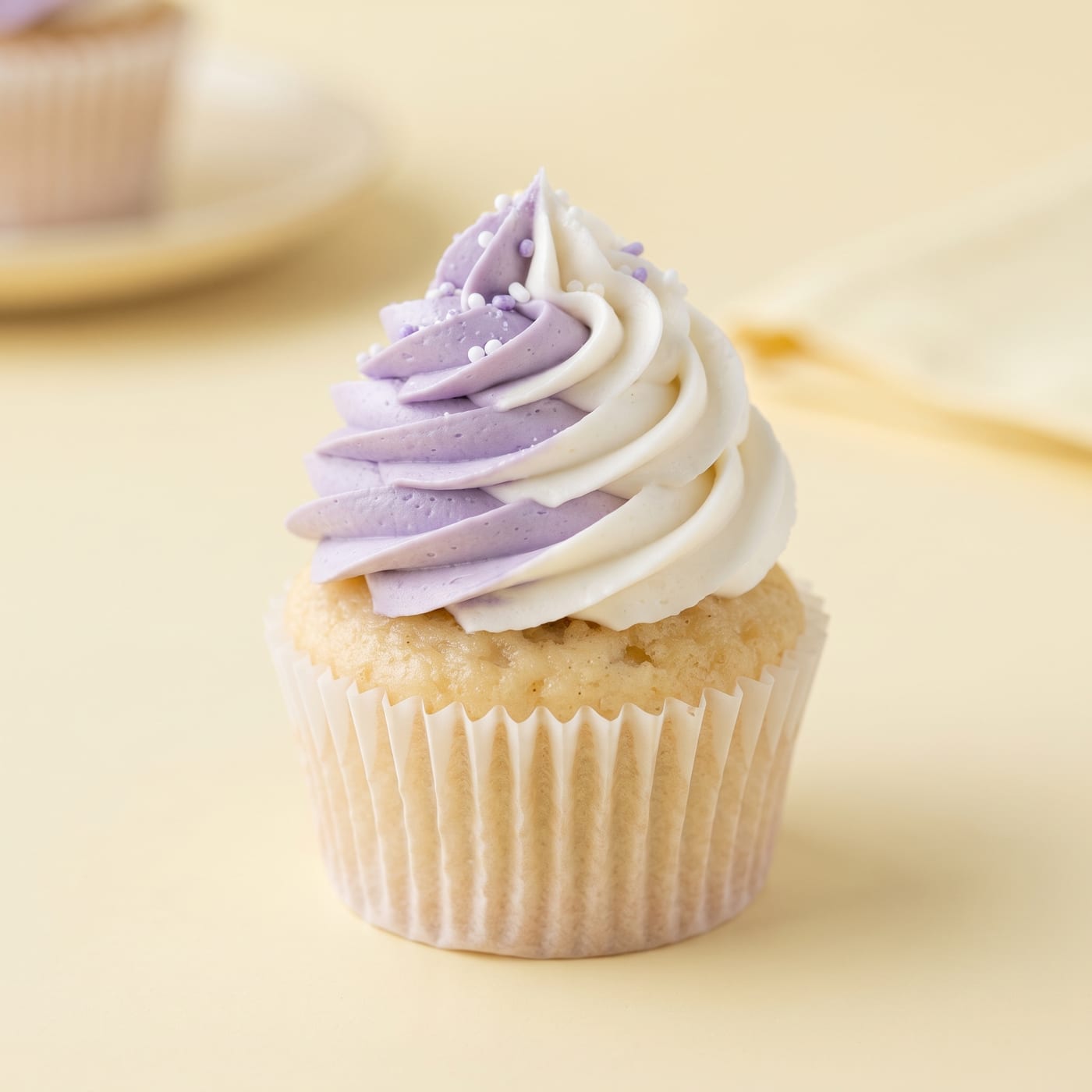 Close up of a two-tone frosting swirl showing a clean color split on a cupcake
