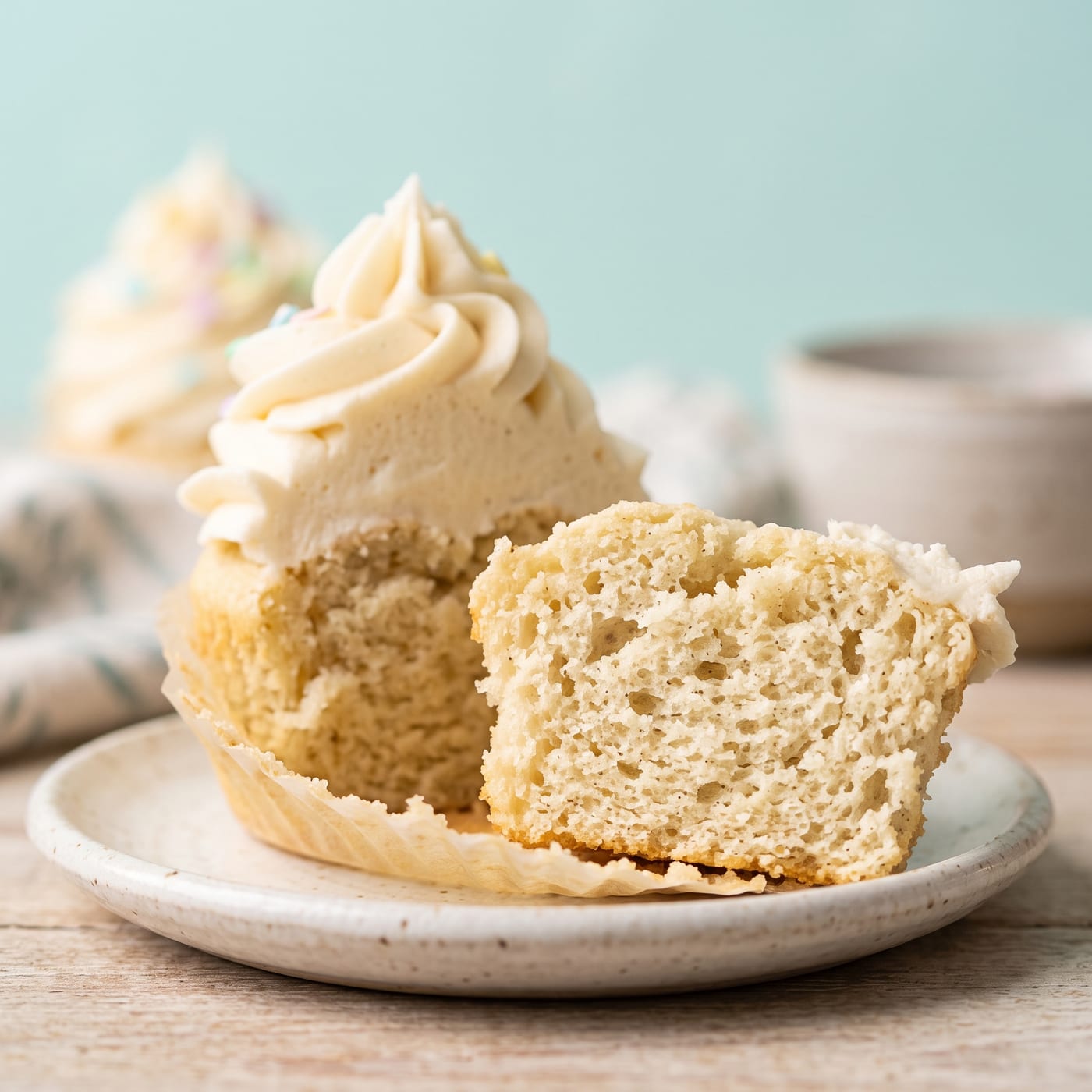 Close up of a keto vanilla cupcake crumb showing a light, airy texture
