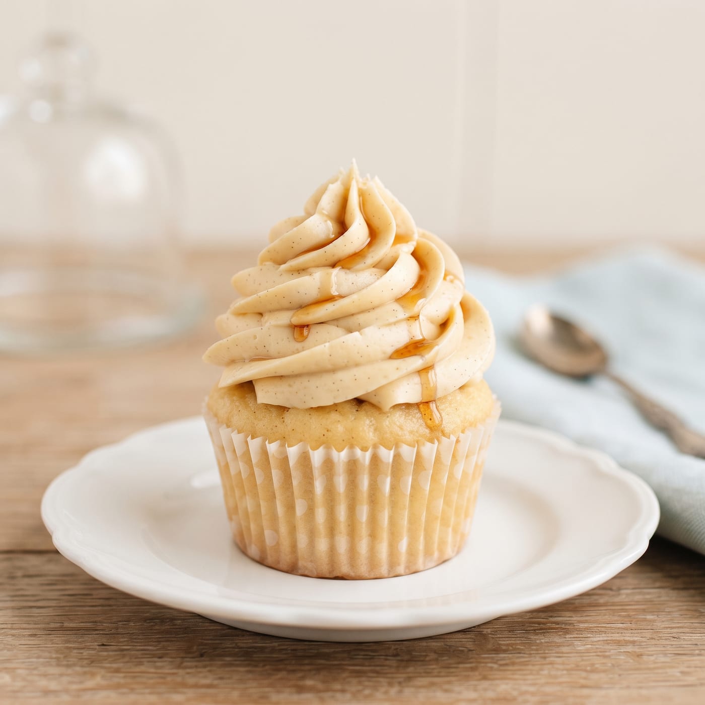 Close up of maple frosting swirl with a thin maple syrup drizzle on top