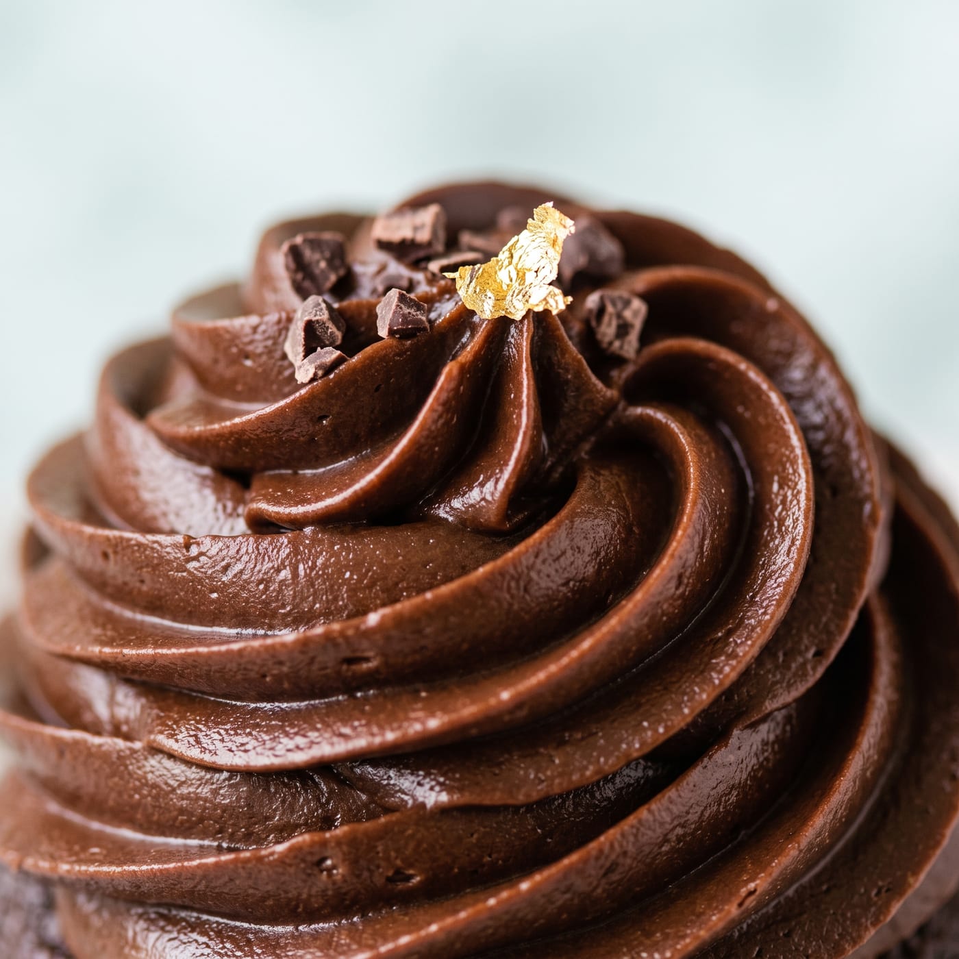 Close up of a fudge frosting swirl showing a smooth glossy texture