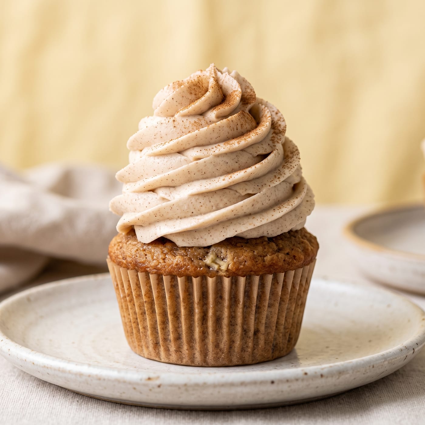 Close up of cinnamon swirl frosting texture on a banana cupcake