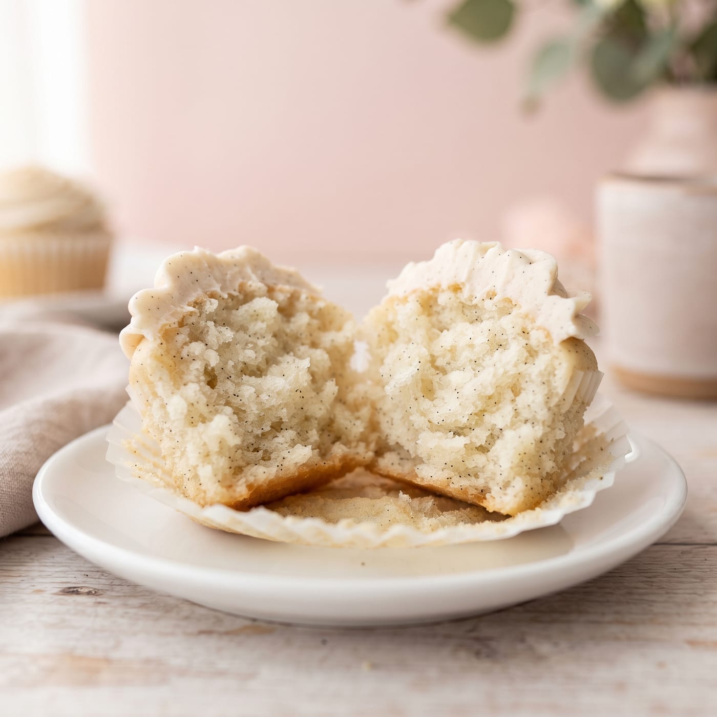 Close up of vanilla bean cupcake crumb showing soft fluffy texture